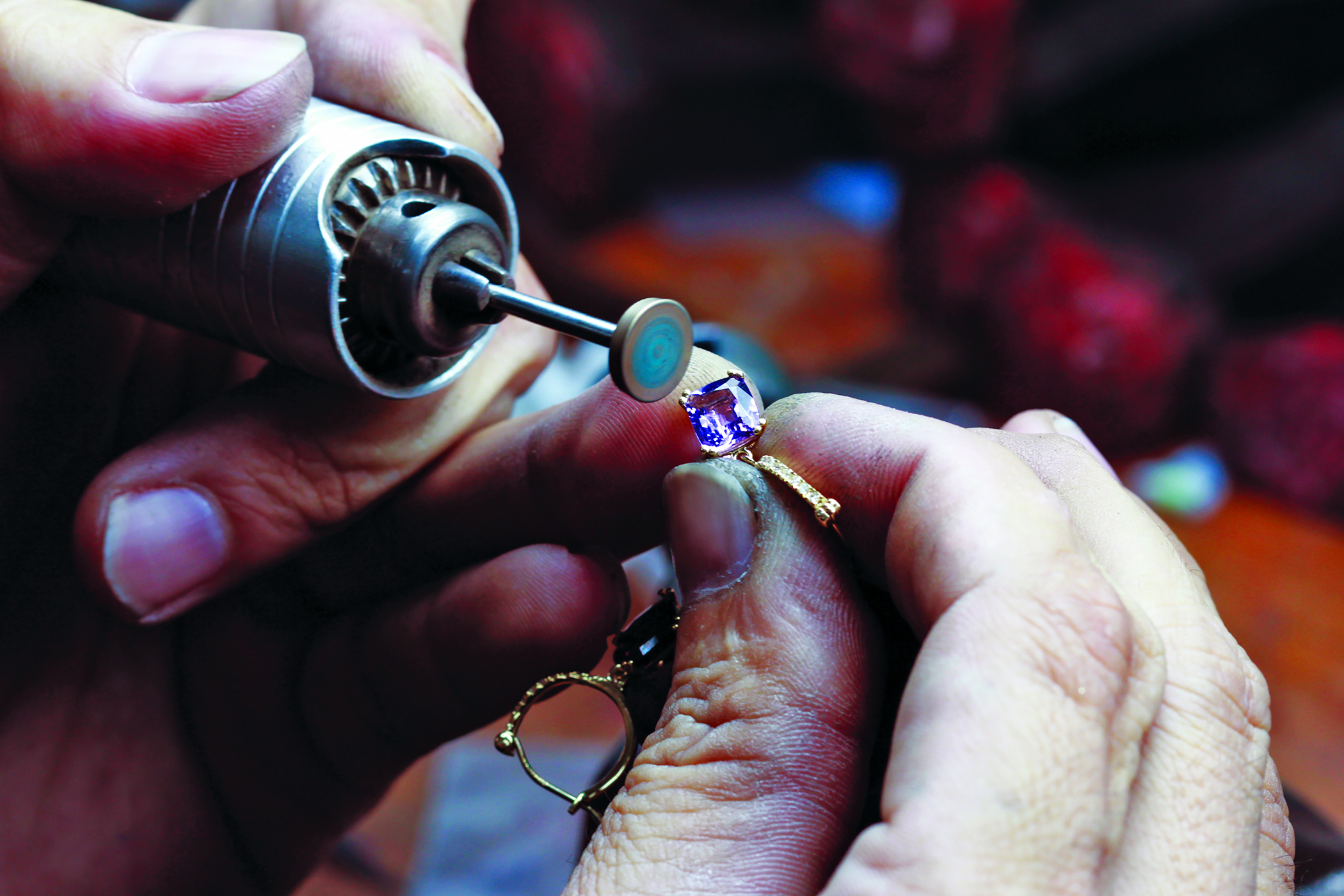 A pair of hands creating a custom piece of jewelry